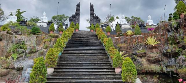 Scalinata di un tempio buddhista a Bali con statue del Buddha